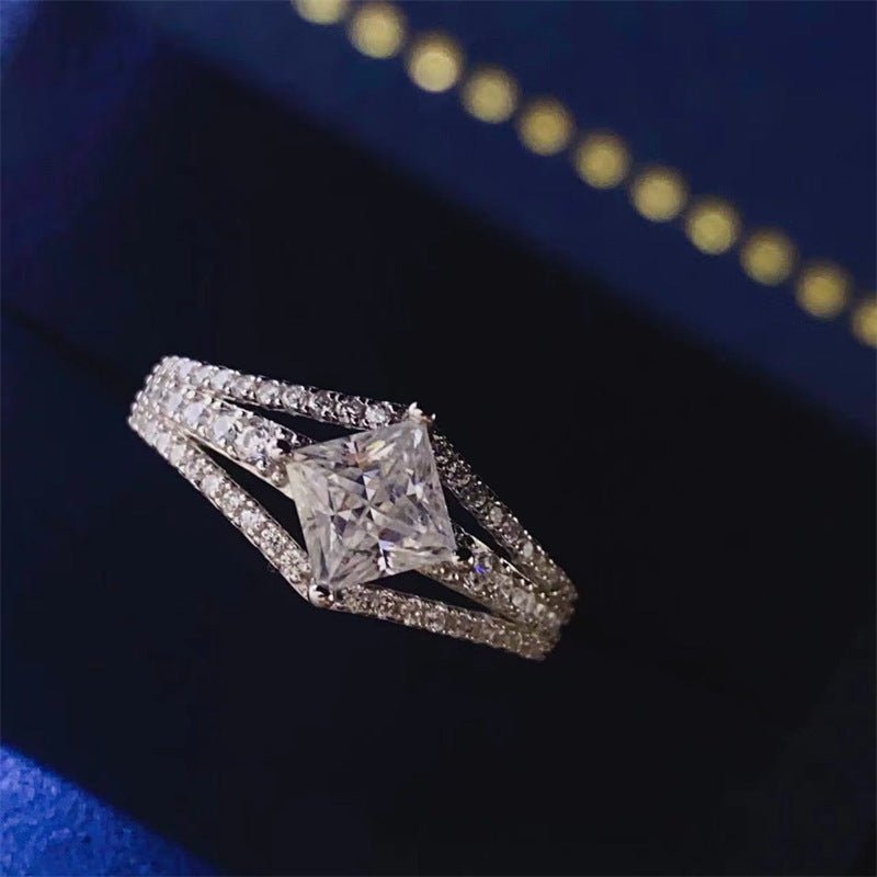 Princess square moissanite ring with U-shaped band.